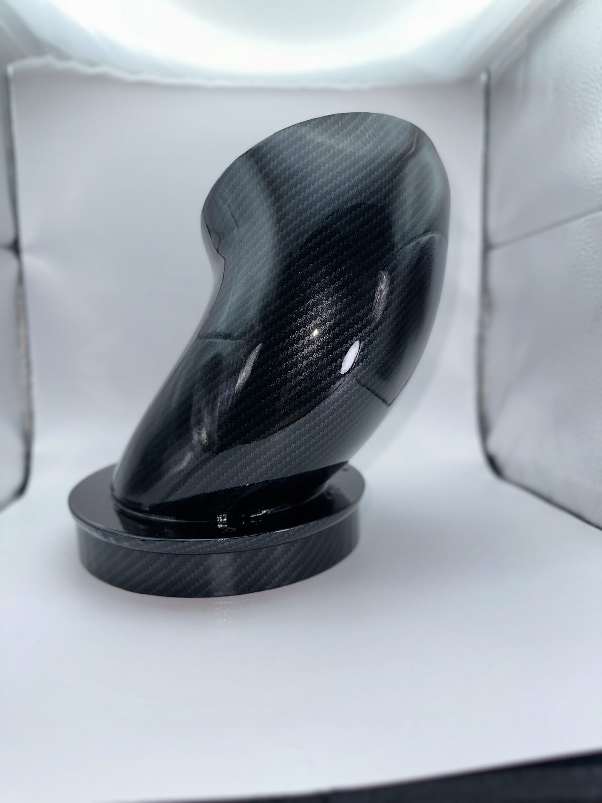 Gloss black intake elbow and adapter ring on a white backdrop